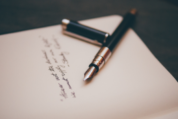 image of a pen and writing